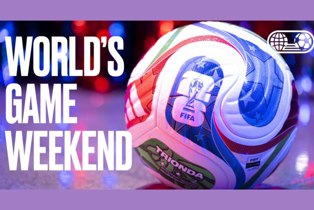 A close-up of a FIFA soccer ball on a shiny surface with colorful lights in the background. Large white text reads "WORLD'S GAME WEEKEND" beside a soccer-themed logo.