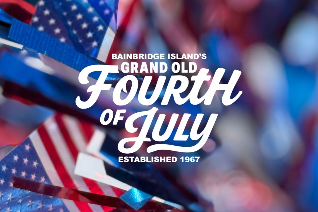 Close-up of American flag-themed decorations with the text "Bainbridge Island's Grand Old Fourth of July Established 1967" in bold white letters across the center.