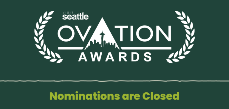 Graphic for the Visit Seattle Ovation Awards with a city skyline inside a triangle, laurel branches on each side, and text stating “Nominations are Closed” at the bottom.