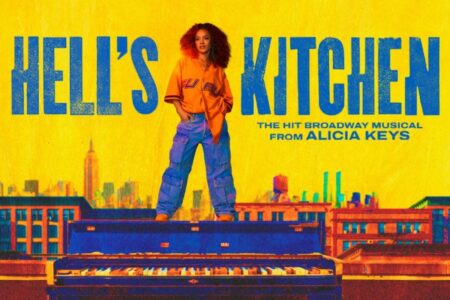 A woman with curly hair stands on a piano, set against a yellow background with a city skyline. Large blue text reads 