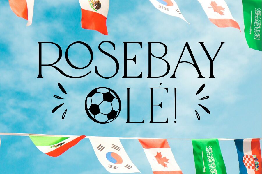 Colorful international flags hang against a blue sky above bold text reading "ROSEBAY OLÉ!" with a soccer ball in the word "OLÉ!.