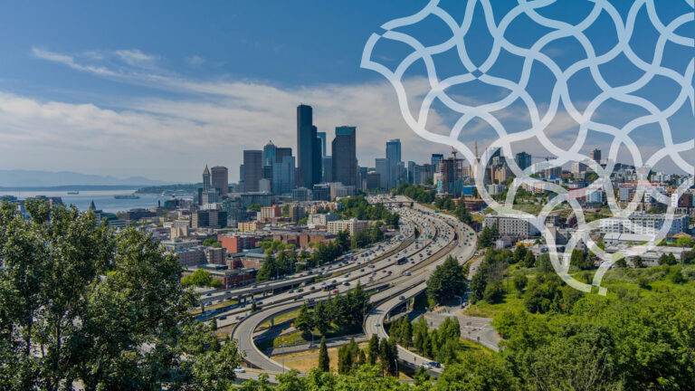 A city skyline with tall buildings and highways, surrounded by greenery under a blue sky. A white geometric pattern overlays the top right corner of the image.