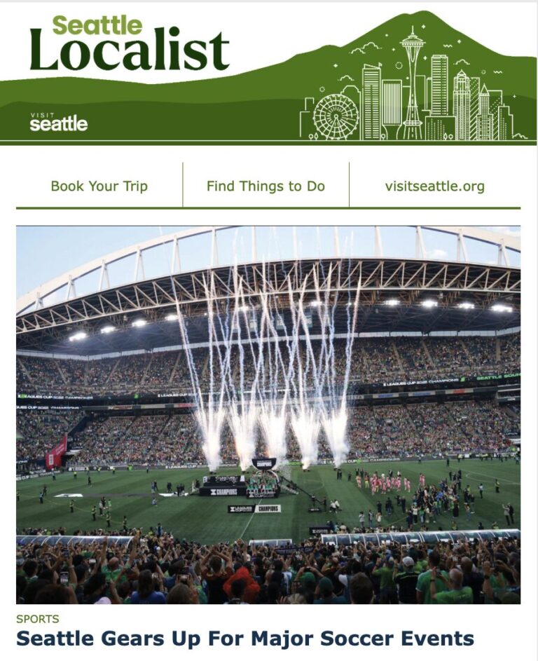 A packed stadium with cheering fans and white fireworks shooting up from the field during a soccer event, under the headline "Seattle Gears Up For Major Soccer Events.