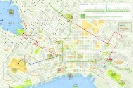 Map showing downtown Seattle with landmarks, parks, and neighborhoods. Various transit routes are highlighted in red, green, and blue lines. Bodies of water, piers, and key destinations are also depicted with icons.