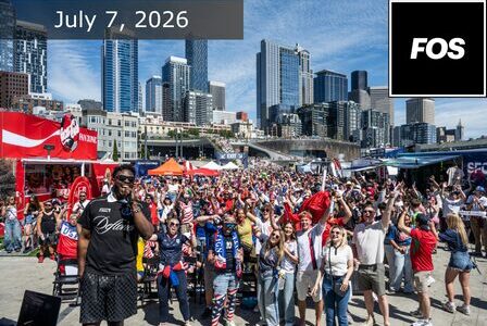 A large crowd of excited people gathers outdoors in a city with tall buildings, many wearing sports gear and waving flags. A man with a microphone stands in front. Text reads “July 7, 2026” and “FOS.”.