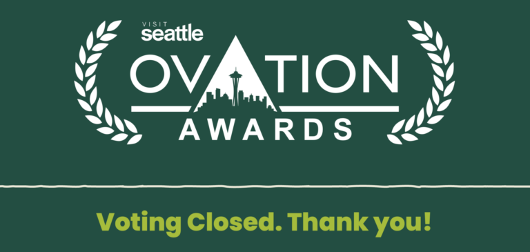 Green graphic for Visit Seattle Ovation Awards. Seattle skyline is in the logo. White laurel leaves frame the text. Below, yellow text reads: “Voting Closed. Thank you!”.