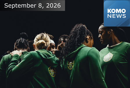 A women’s basketball team in green huddles together. The date “September 8, 2026” appears above, and a blue KOMO News logo is in the top right corner.