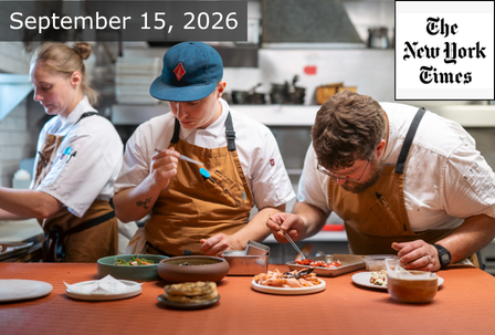 Three chefs in aprons prepare dishes in a busy kitchen. A “The New York Times” logo and the date “September 15, 2026” are overlaid on the image.