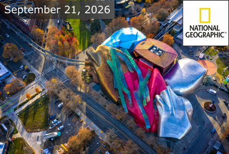 Aerial view of a colorful, uniquely shaped building surrounded by trees and streets, with “September 21, 2026” and the National Geographic logo displayed at the top.