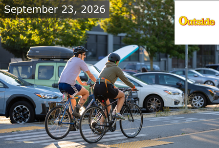 Two people ride bicycles on a sunny day beside parked cars. Text reads “September 23, 2026” in the corner, with the “Outside” logo also visible. Trees and urban details appear in the background.